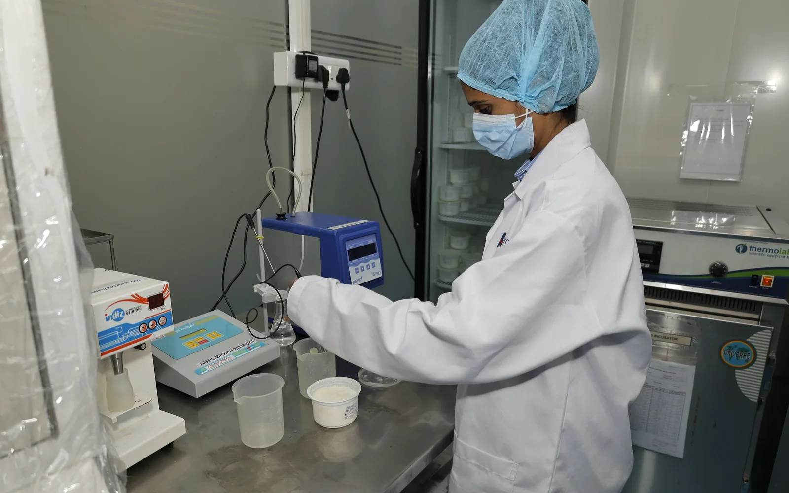 A technologist taking a reading from a sample at the in-process QC bench